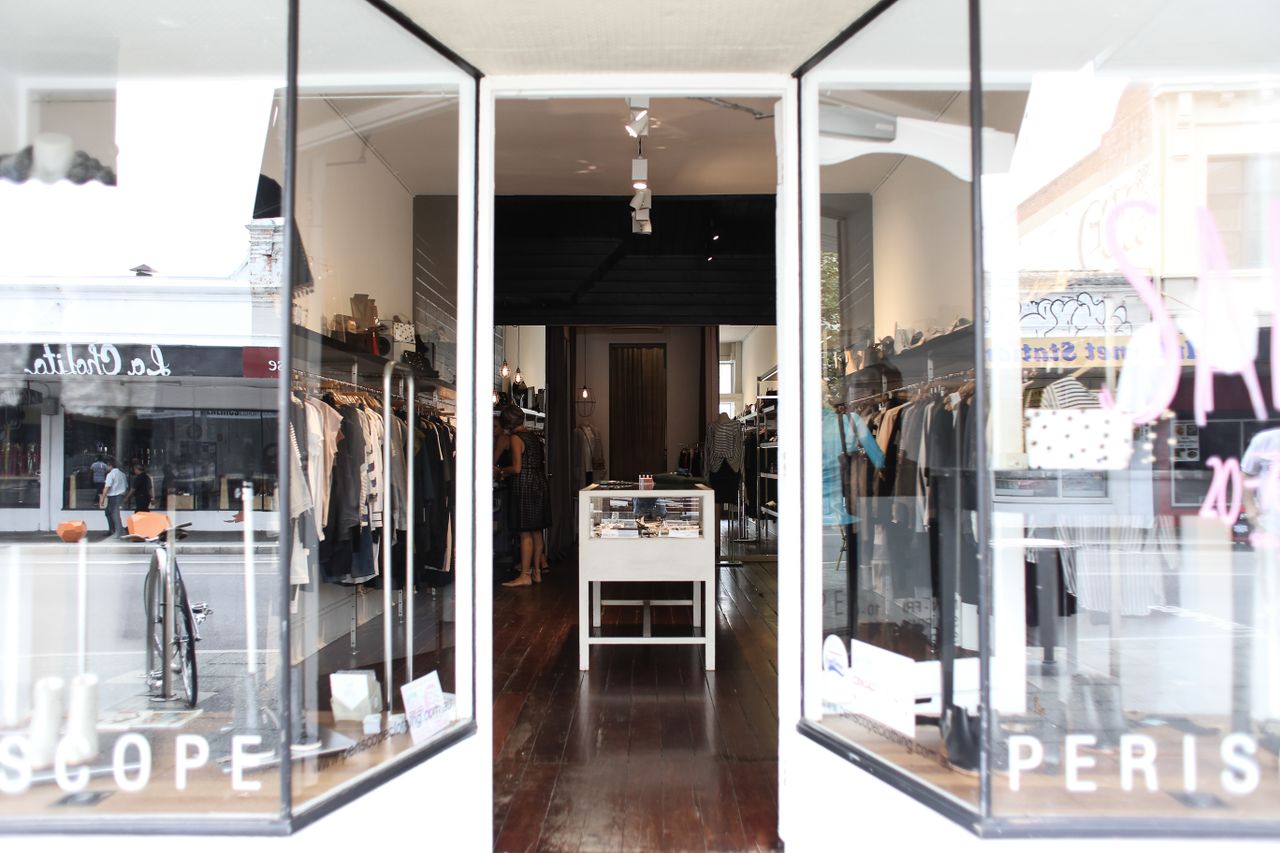 Elegant boutique showcasing clothing and accessories in a chic, modern setting.